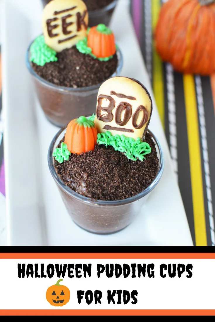 Clear plastic cups layered with chocolate pudding, orange whipped cream, and candy “spiders” on a festive table